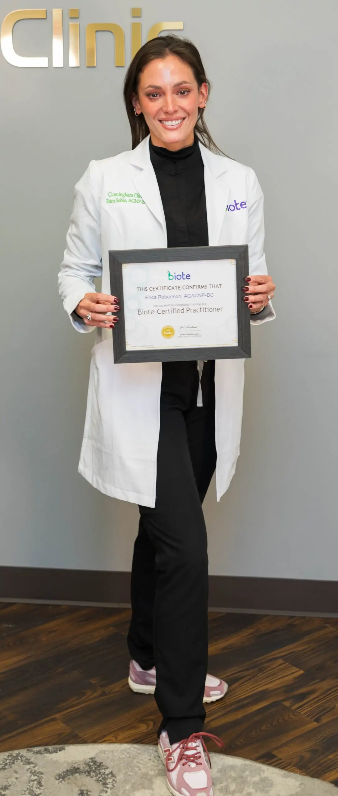 Erica holding her Biote Certification close up
