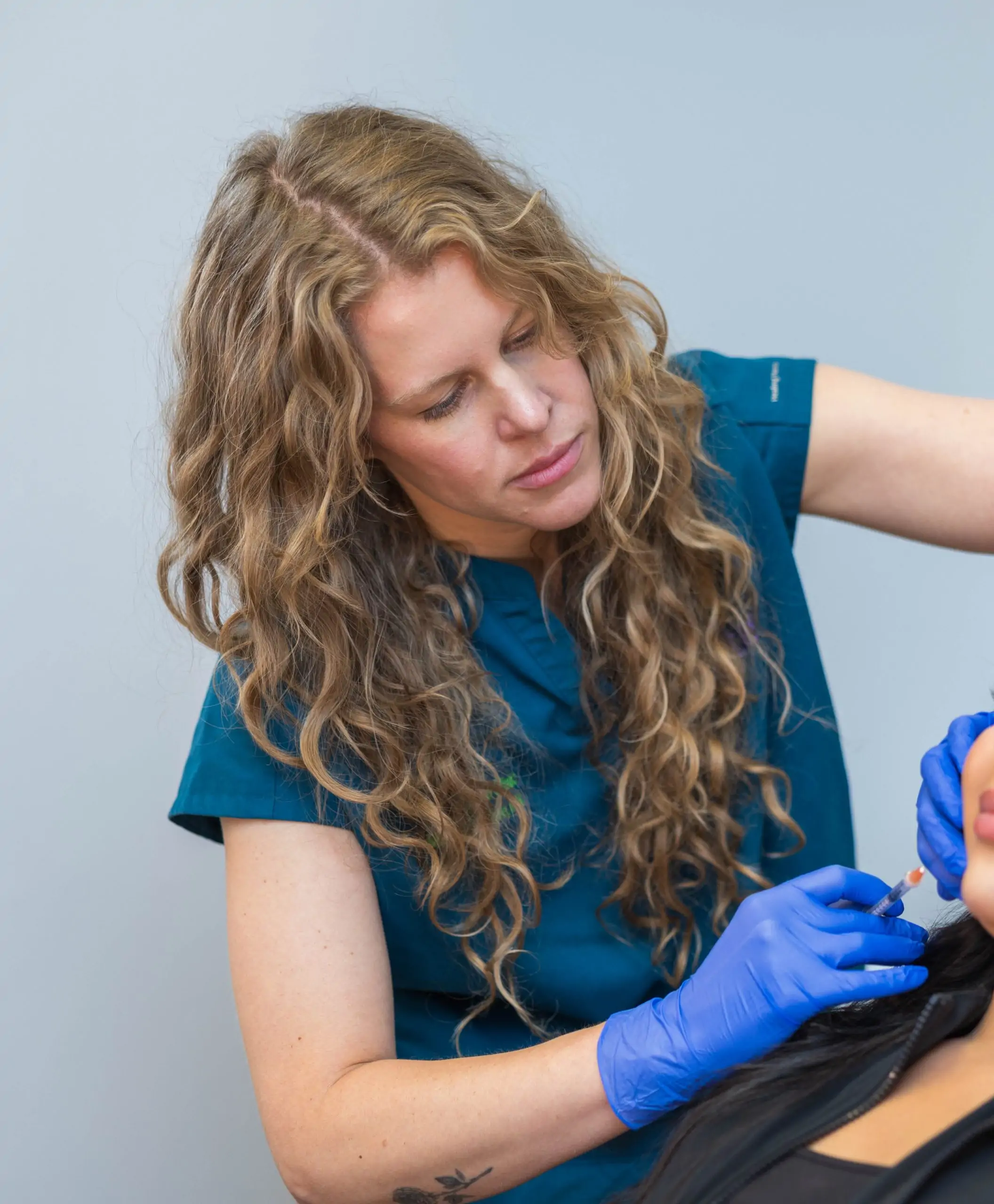 close up of focused marissa operating on a patient